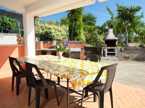 einen Tisch und Stühle auf einer Terrasse mit Kamin in der Unterkunft Villa Villa Caiterzi by Interhome in Lanuvio