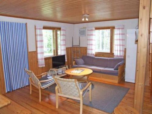 sala de estar con sofá, mesa y sillas en Holiday Home Kumpulahti by Interhome, en Käylä