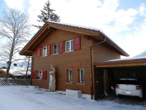 a house with a car parked in front of it at Apartment Schön-Egg by Interhome in Zweisimmen