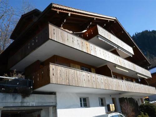 a building with wooden balconies on top of it at Apartment Fabiana by Interhome in Zweisimmen