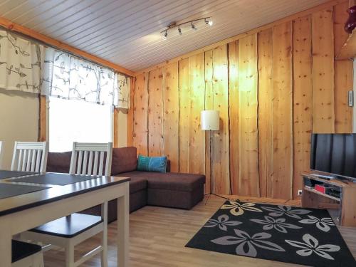 a living room with a couch and a table at Holiday Home Aarre b by Interhome in Saariselka