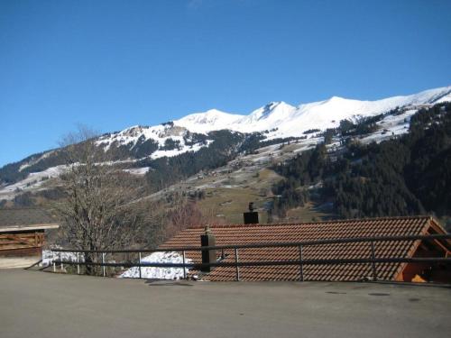 a view of a snow covered mountain from a house at Apartment Arnika # 2 by Interhome in Lenk