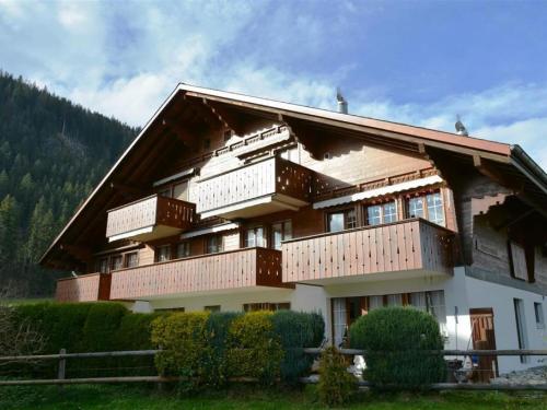 a large building with balconies on the side of it at Apartment Simmental by Interhome in Zweisimmen