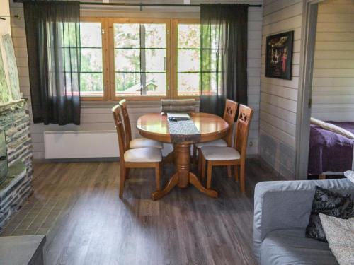 - une salle à manger avec une table, des chaises et un canapé dans l'établissement Holiday Home Lomasyväri 806 by Interhome, à Tahkovuori