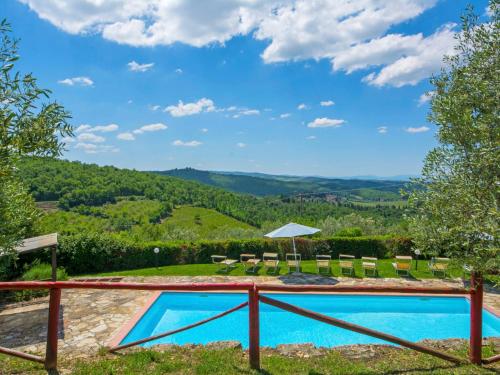 a swimming pool with a view of the mountains at Holiday Home Badia a Passignano-2 by Interhome in Badia A Passignano