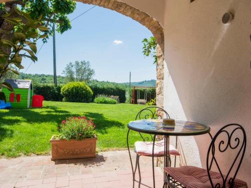 a patio with a table and chairs and a yard at Apartment Badia a Passignano-3 by Interhome in Badia A Passignano