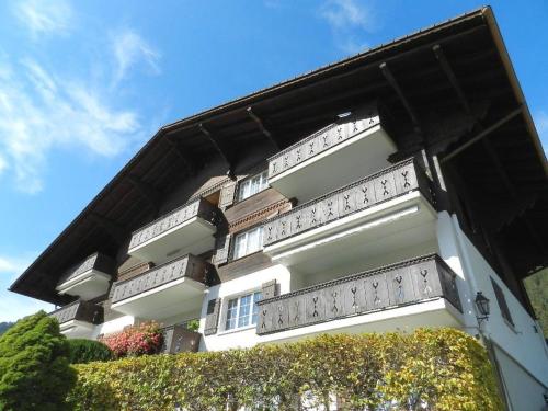 a white building with balconies on the side of it at Apartment Fink by Interhome in Zweisimmen
