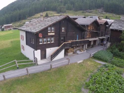 an aerial view of a large wooden building at Apartment Talblick by Interhome in Saas-Grund