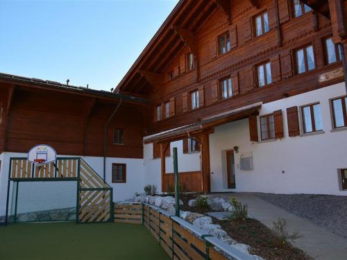 a basketball hoop in front of a wooden building at Apartment Mireille Nr- 6 by Interhome in Gstaad