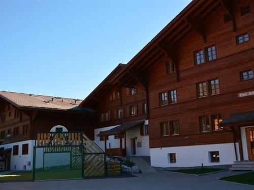 a large wooden building with a sign in front of it at Apartment Anne - Hochparterre by Interhome in Gstaad