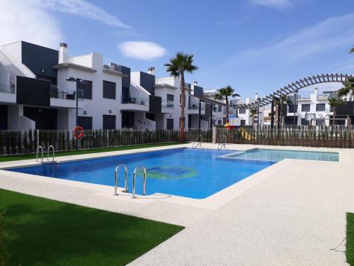 a swimming pool in front of some apartments at Penthouse Lamar 43.11 in Pilar de la Horadada