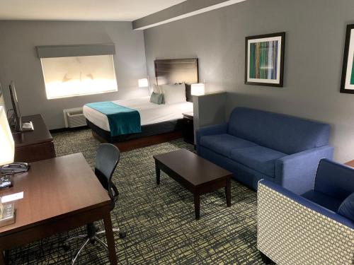 a hotel room with a couch and a bed at Best Western Plus Olive Branch Hotel & Suites in Olive Branch