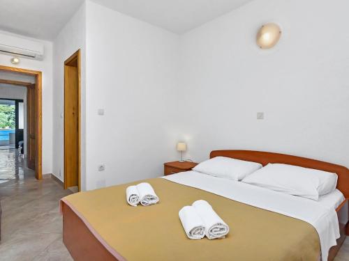 a bedroom with a bed with white towels on it at Apartment Rubin-1 by Interhome in Selca kod Bogomolja