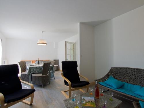 a living room with a couch and chairs and a table at Holiday Home Tal Mor by Interhome in Quiberon