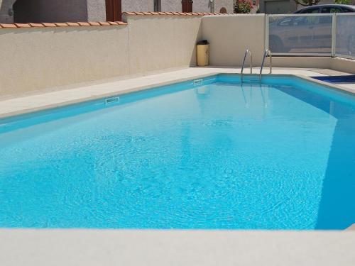 a large swimming pool with blue water at Holiday Home Les Privileges by Interhome in Saint-Palais-sur-Mer