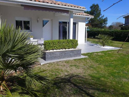 a white house with a porch and a yard at Holiday Home Sainte Marie by Interhome in Tosse