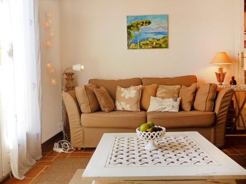 a living room with a couch and a table at Holiday Home Domaine des Vignes by Interhome in Cogolin