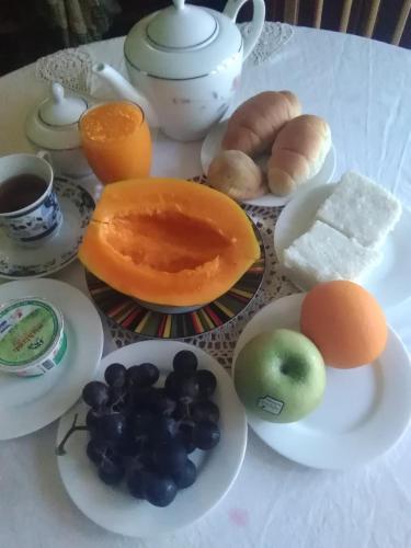 a table topped with plates of fruit and other foods at VILLA ARIANNA in Wattala