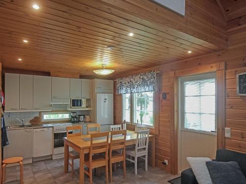 a kitchen and dining room with a table and chairs at Holiday Home Aallotar havina by Interhome in Paltamo