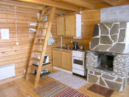 a kitchen with a stove and a ladder in a cabin at Holiday Home Kallela by Interhome in Jokijärvi
