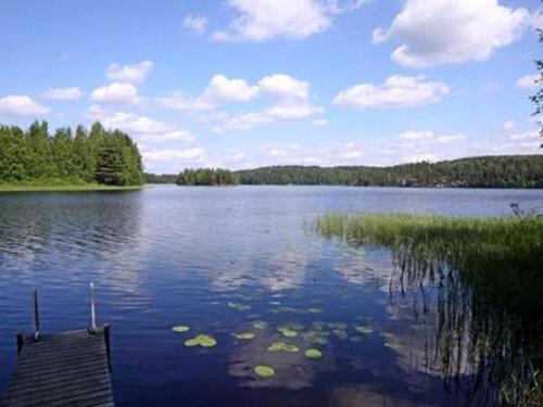 a large lake with a dock in the middle of it at Holiday Home Rantatupa by Interhome in Hyyrylä