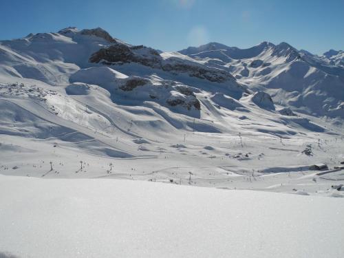 a group of people skiing down a snow covered mountain at Apart Garni Sesvenna in Ischgl