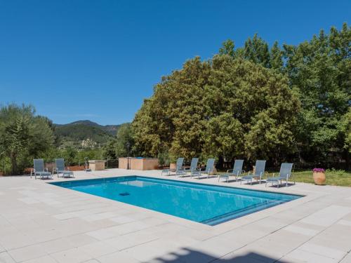 a swimming pool with lounge chairs at Villa Les Mines by Interhome in Selva
