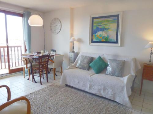a living room with a couch and a table at Apartment l'Amiral by Interhome in Trouville-sur-Mer
