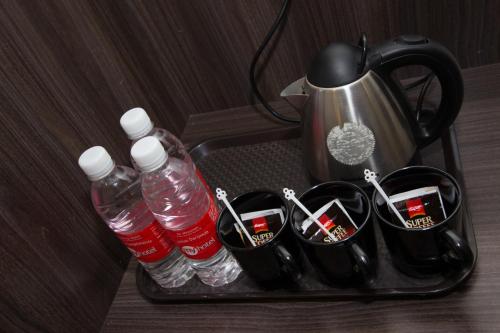 a tray with water bottles and cups and a tea pot at My Hotel @ Sentral in Kuala Lumpur