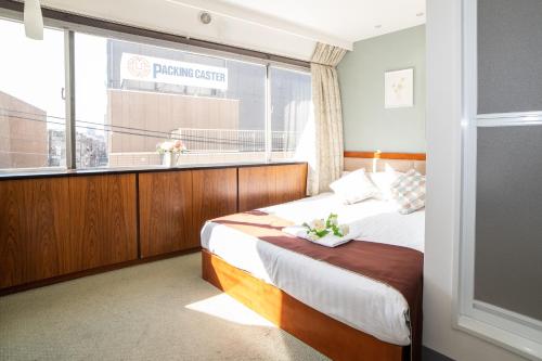 Ένα ή περισσότερα κρεβάτια σε δωμάτιο στο Tabata Oji Hotel