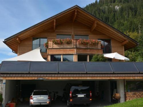 a house with two cars parked in front of it at Apartment Bolzli-Hus by Interhome in Blankenburg