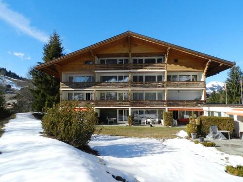 a large building with snow in front of it at Apartment La Sarine 212 by Interhome in Gstaad