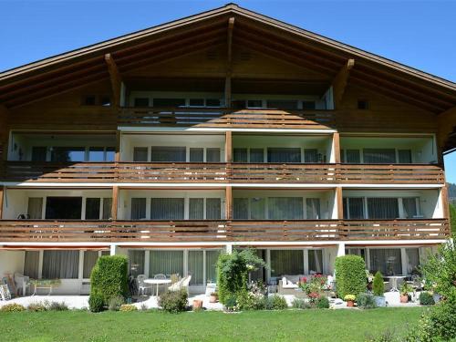 a large apartment building with a large deck at Apartment La Sarine 124 by Interhome in Gstaad