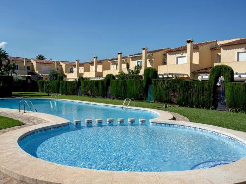 a swimming pool in the middle of a yard at Apartment El Datiler by Interhome in Denia