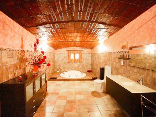 a large bathroom with a tub and a sink at Holiday Home L'Aldea by Interhome in L'Aldea