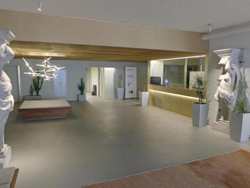 a large room with statues and plants in it at Apartment Classic by Interhome in Luzern