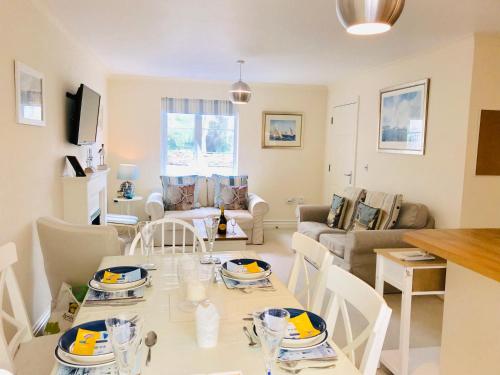 a kitchen and living room with a table and chairs at Chestnut Cottage, Shanklin Rural Retreat in Shanklin