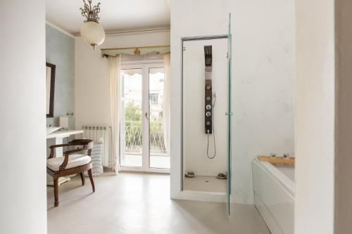 a bathroom with a shower and a glass door at Classy lux apt w/ sea view, garden, parking in Corfu