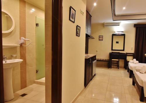 a room with a bathroom with a sink and a toilet at 24 Seven Boutique Hotel in Malia