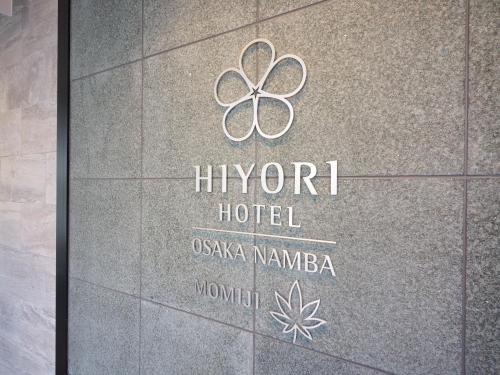 a sign for the hyront hotel on a building at Hiyori Hotel Osaka Namba Station in Osaka