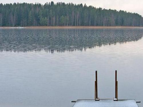 a dock in the middle of a large lake at Holiday Home Kopinkallio 1 by Interhome in Vääksy