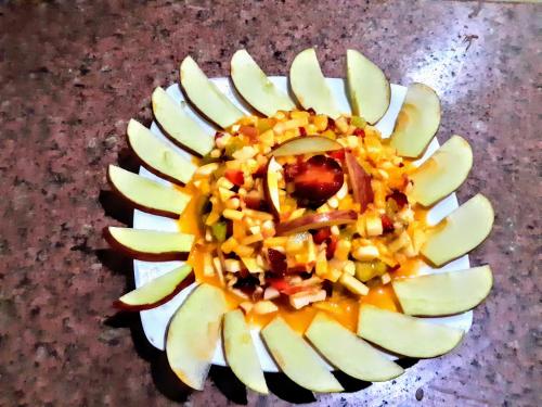 a plate of food with a yellow flower on a table at Yasmina Beach in Taba