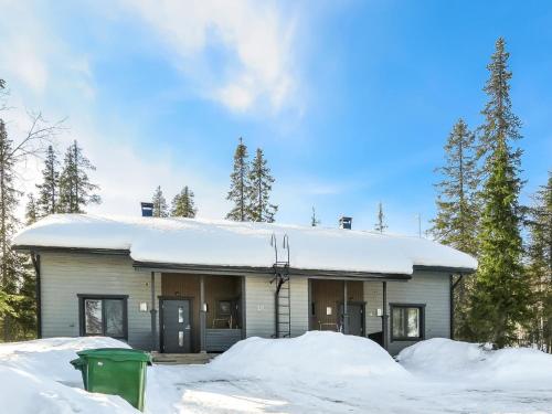 a building covered in snow with snow piled up at Holiday Home Aihki a by Interhome in Syöte