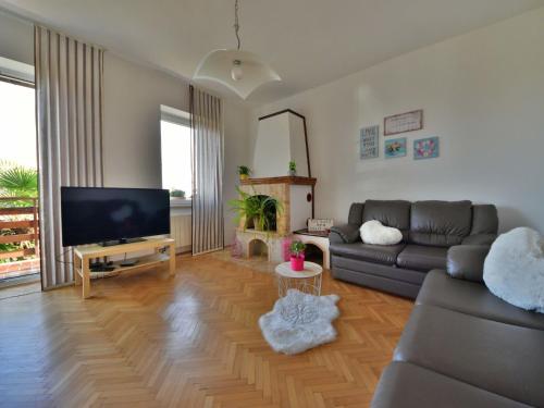 a living room with a couch and a flat screen tv at Apartment Karlo by Interhome in Rukavac