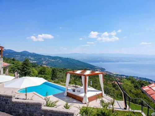 a villa with a swimming pool and a view at Villa Marone by Interhome in Dobreć