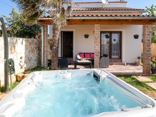 a hot tub in the backyard of a house at Holiday Home Villa Aurora by Interhome in Loborika