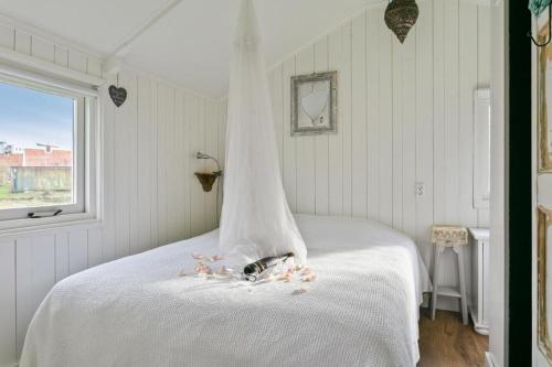 a white bed with a veil on top of it at Rietzicht in Alkmaar