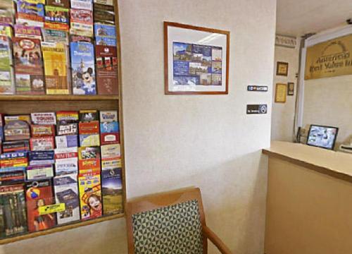 a waiting room with a chair and books on a wall at Americas Best Value Inn - Livermore in Livermore