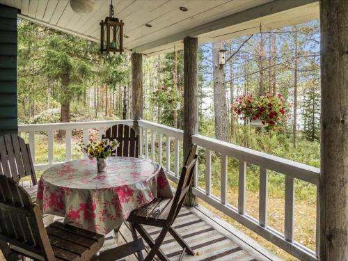 a porch with a table and chairs on it at Holiday Home Huotarin mökki by Interhome in Tervajärvi
