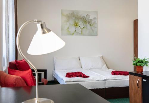 a living room with a couch and a lamp at Masarykova Kolej in Prague